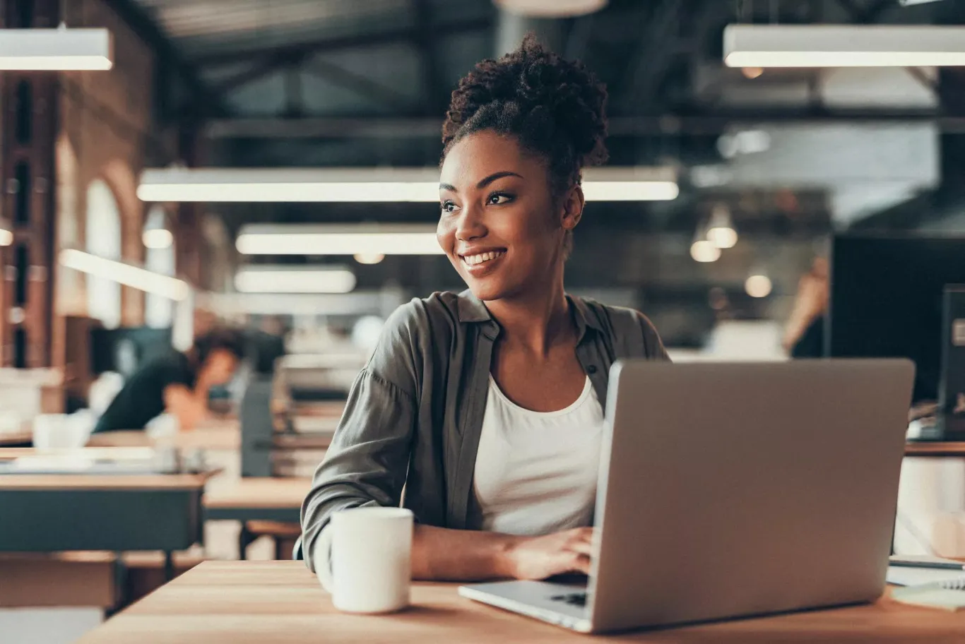 Woman working on tablet in an office setting.